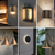 Collage of six modern LED outdoor wall lighting designs, including bubble glass lanterns, geometric sconces, cone-shaped barn lights, circular halo lights, and up-and-down wall fixtures.