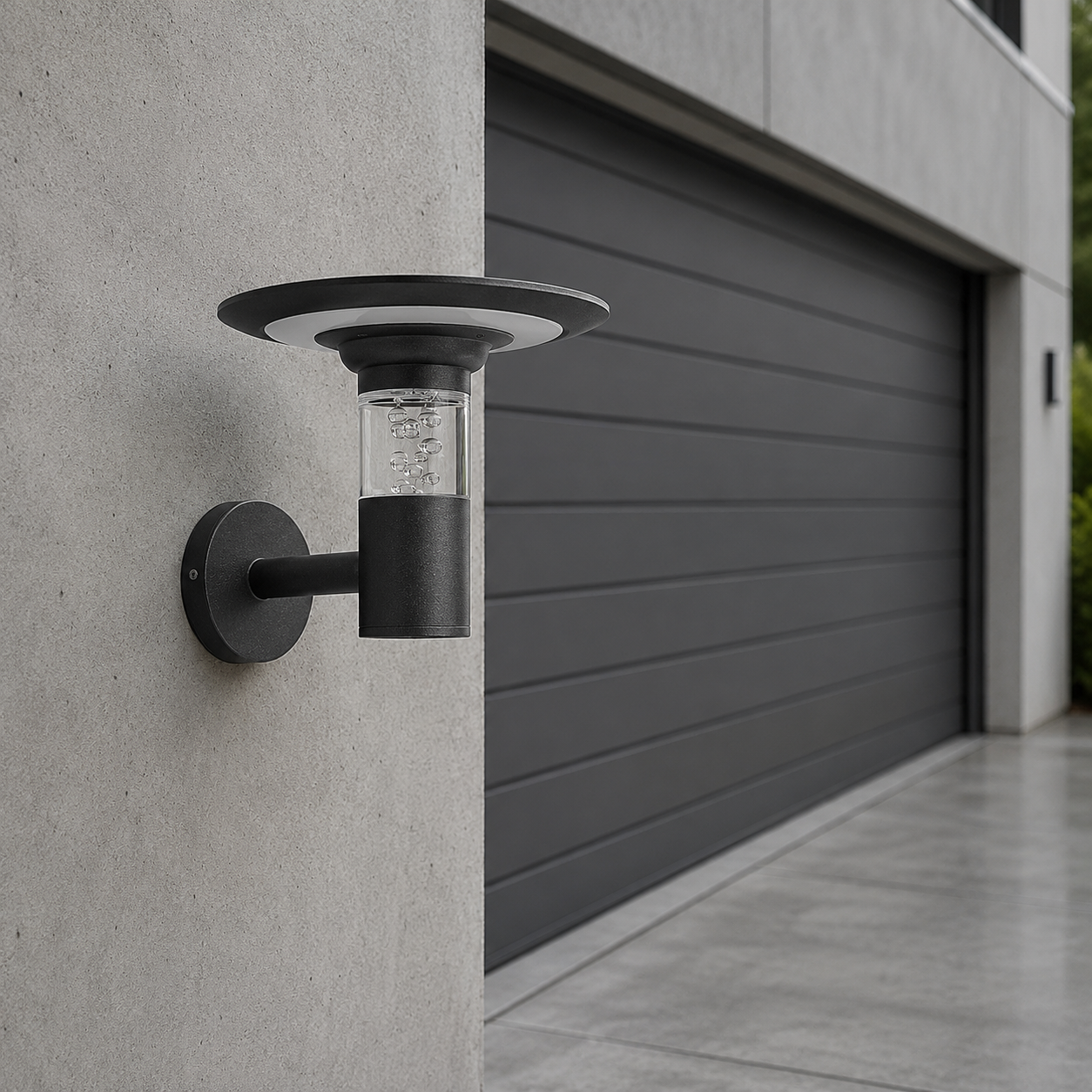 Black aluminium solar exterior wall light mounted beside a modern garage entrance
