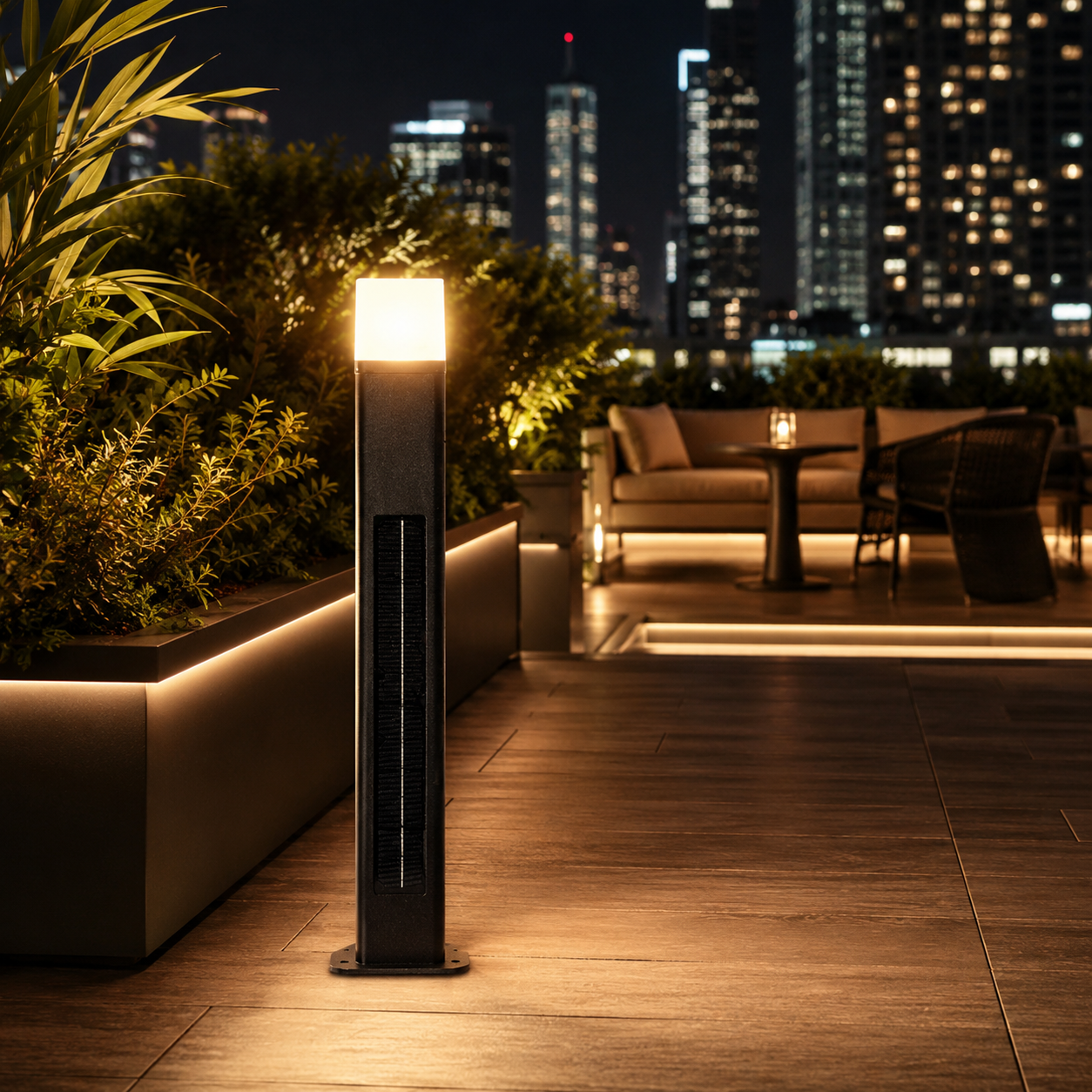 Solar bollard pathway light glowing on a rooftop terrace with city skyline at night