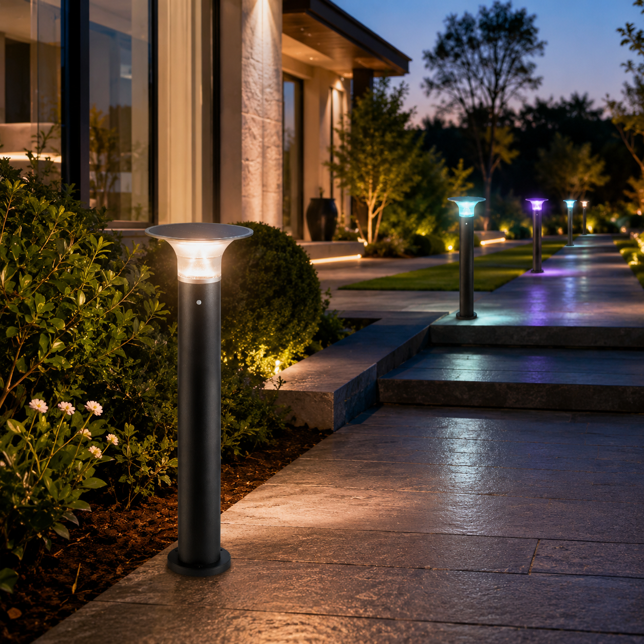 RGB solar bollard pathway lights illuminating a modern garden walkway with warm and colorful accent lighting